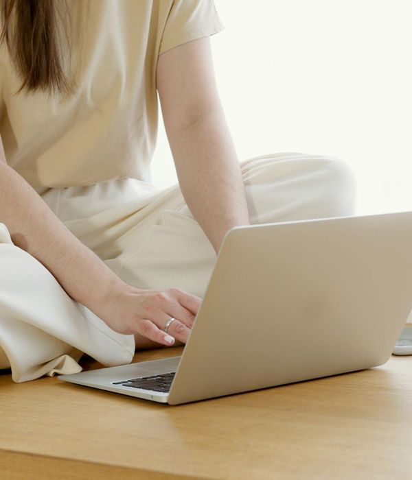 A person sitting at a clean, modern desk with good posture, feeling focused and comfortable
