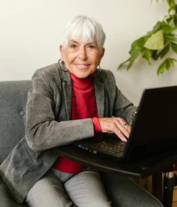 An energetic and happy person looking away from their computer, feeling refreshed